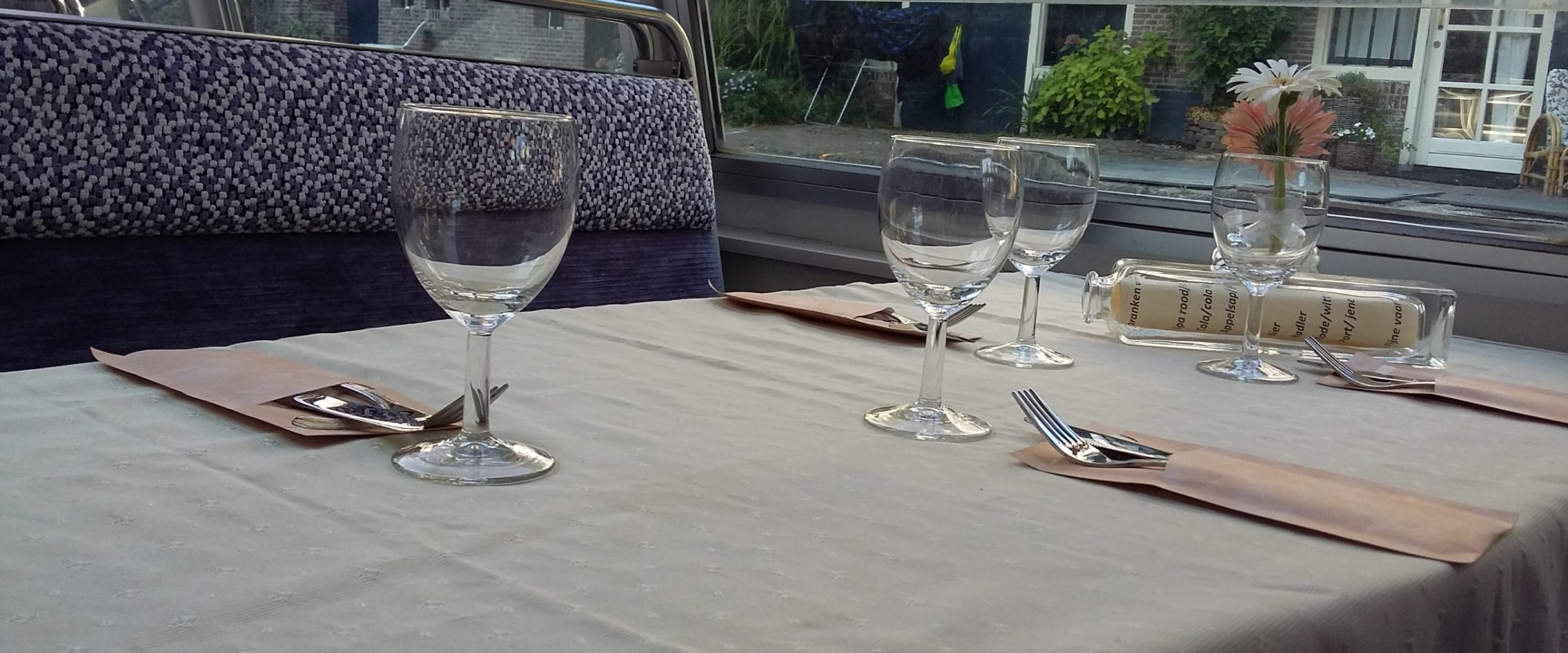 a glass of wine sitting on top of a table