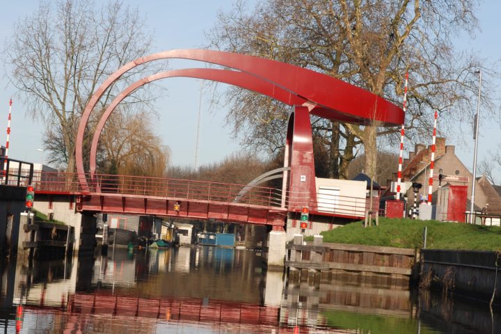 a large long bus on a bridge