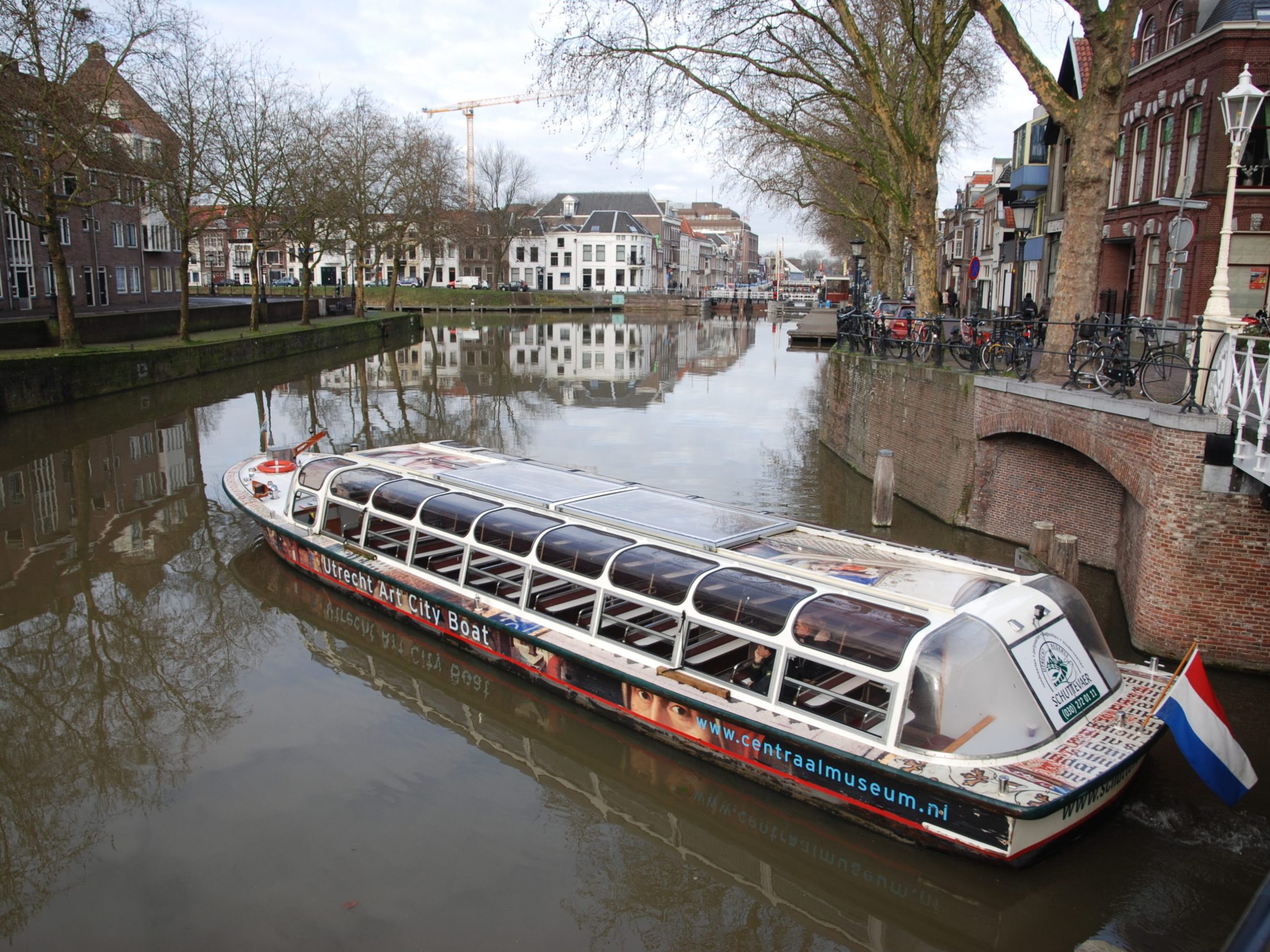 a boat traveling across a bridge over a body of water