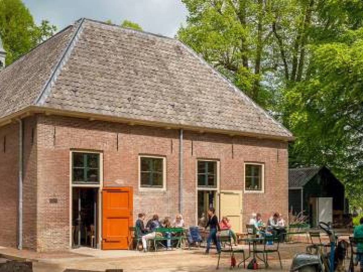 a group of people walking in front of a house