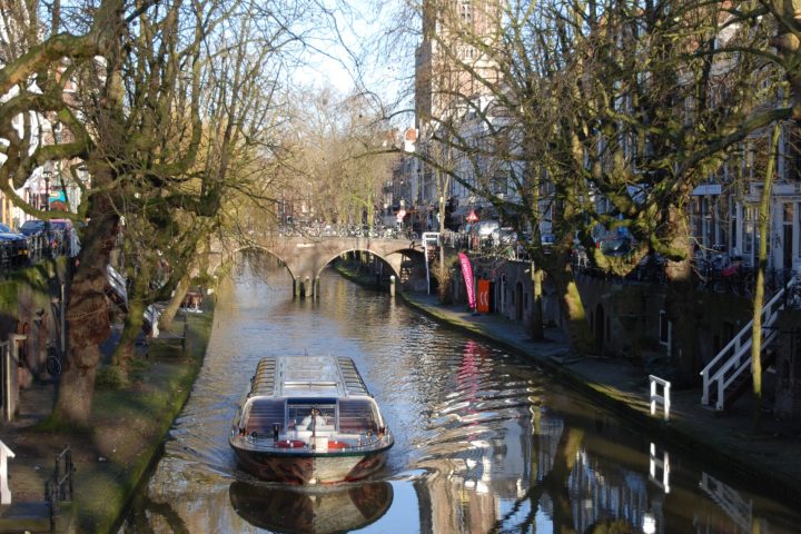 a boat on a river surrounded by trees