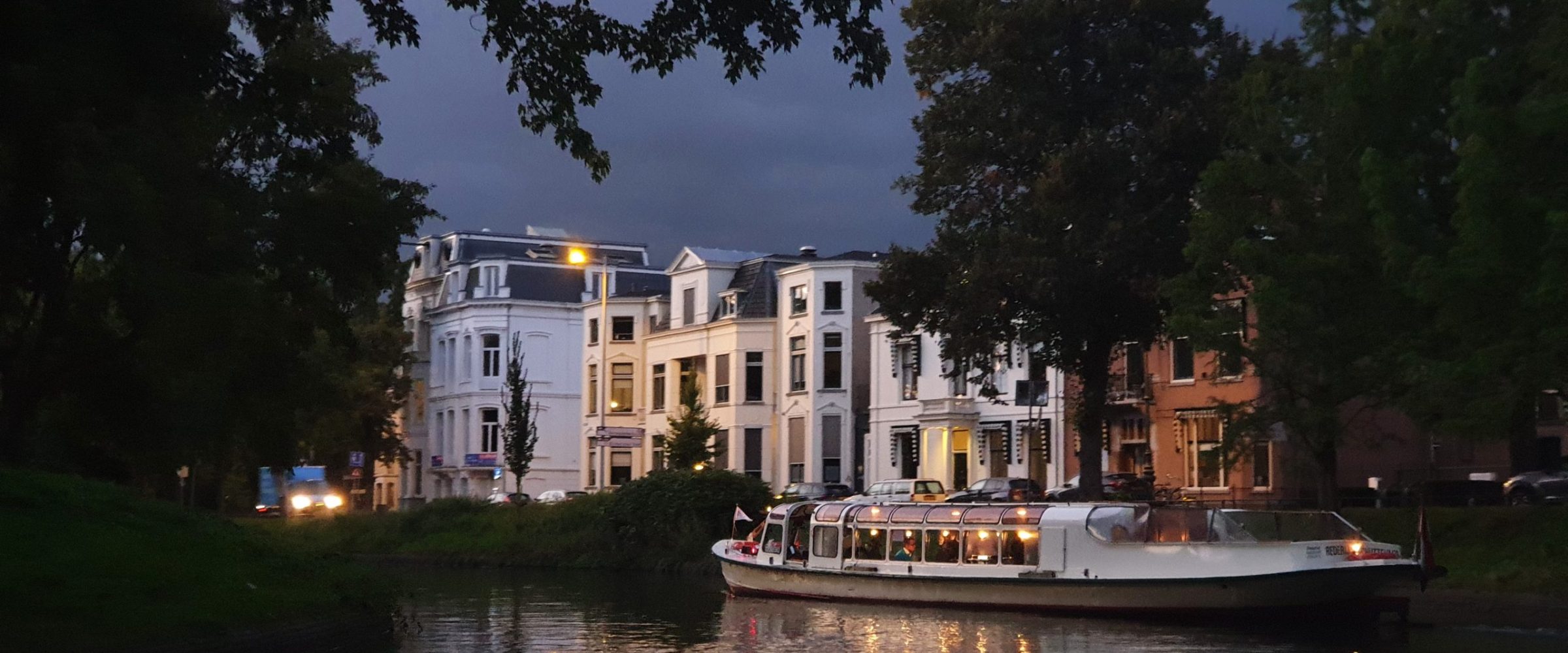 a small boat in a body of water with a city in the background