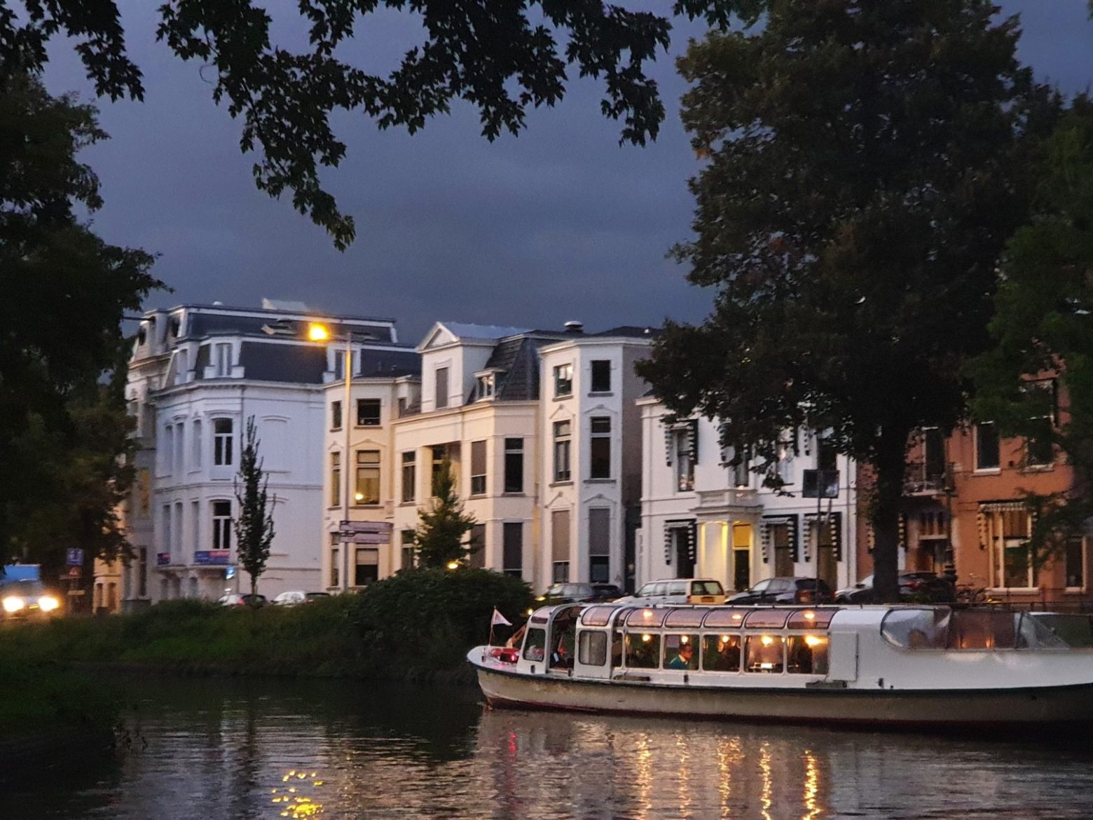 a small boat in a body of water with a city in the background