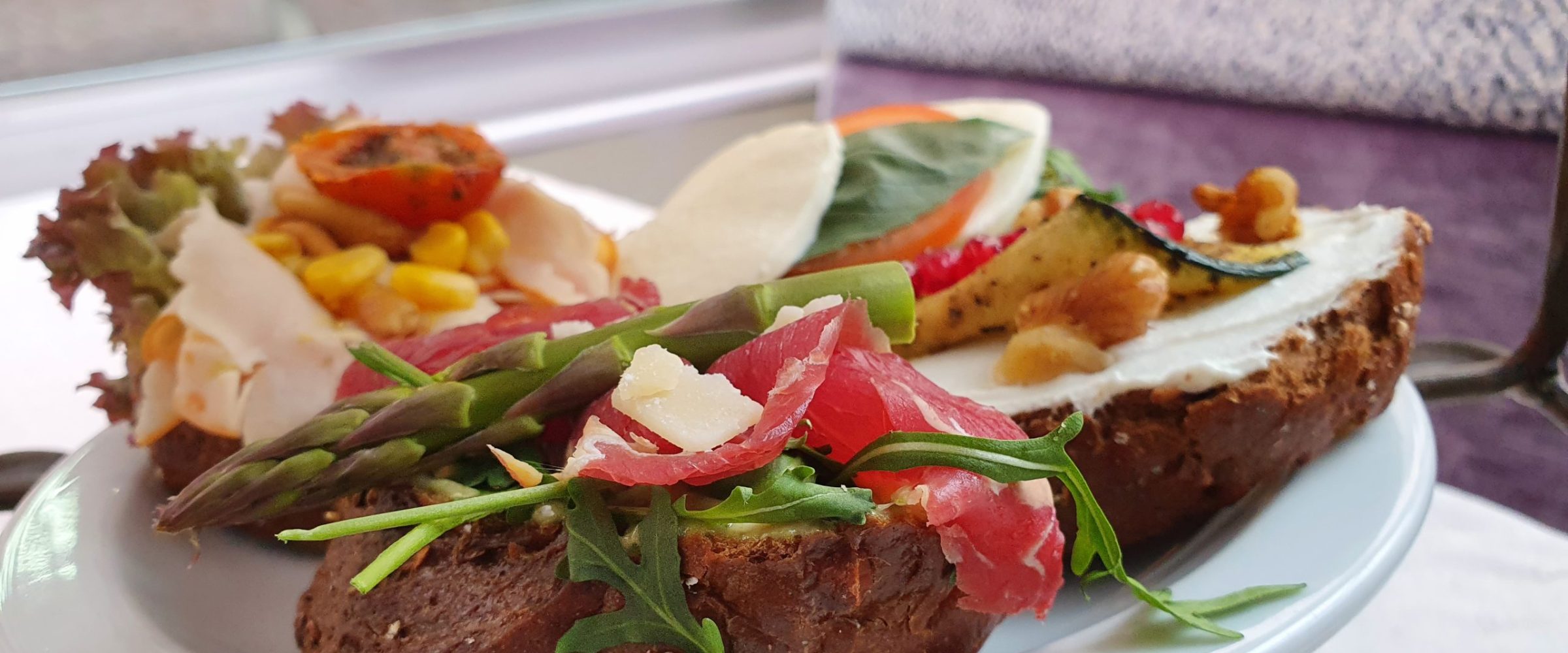 a plate of food with a slice of cake on a table