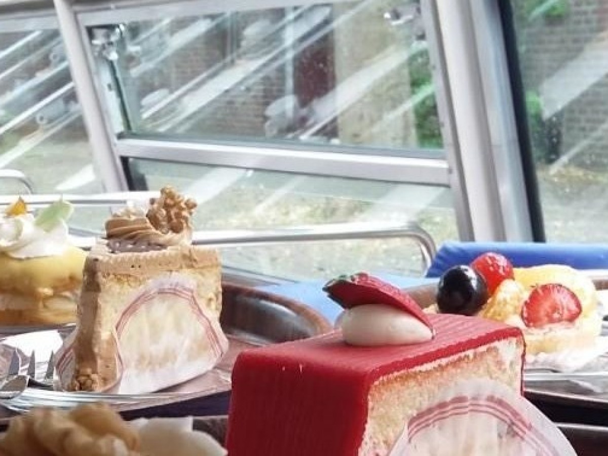 a tray of food on a plate next to a window