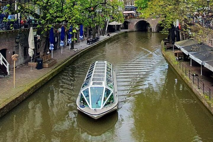 a group of people on a bridge over a river