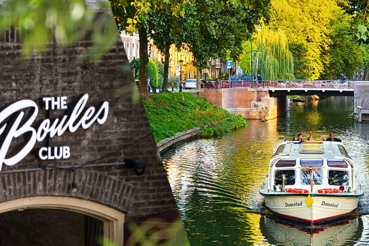 Brick wall with 'The Boules Club' sign and a canal with a boat under trees.